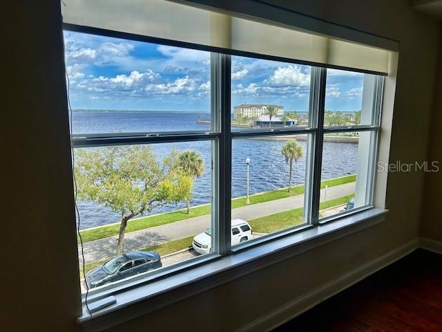 A view of a waterfront park and river through a large three-pane window — 225 W SEMINOLE BOULEVARD UNIT 308, SANFORD, FL