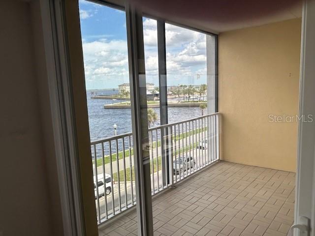 A balcony with tiled flooring overlooks a body of water and a parking area — 225 W SEMINOLE BOULEVARD UNIT 308, SANFORD, FL