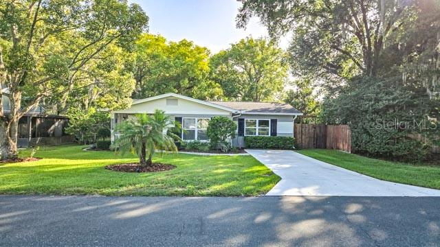 A single-story house with a white exterior, gray roof, and a concrete driveway — 5725 14TH STREET, ZEPHYRHILLS, FL