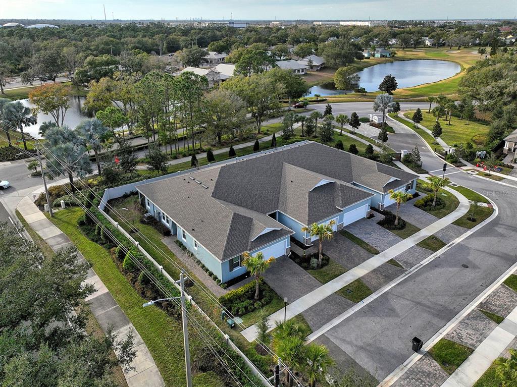 An aerial view of a light blue duplex home with a dark shingled roof — 810 RUDDY QUAIL PLACE, SUN CITY CENTER, FL