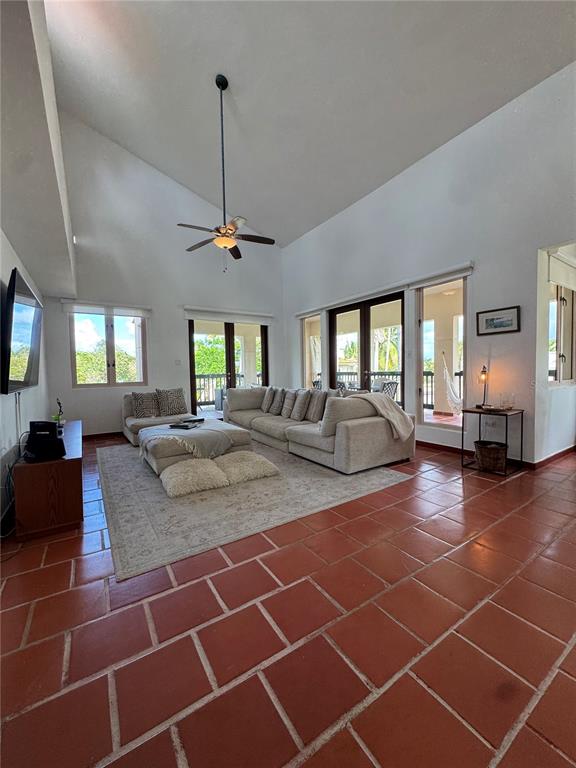 A living room with vaulted ceilings, a ceiling fan, and terracotta tile flooring — 86 LAKESIDE VILLAS UNIT F2, VEGA ALTA, PR