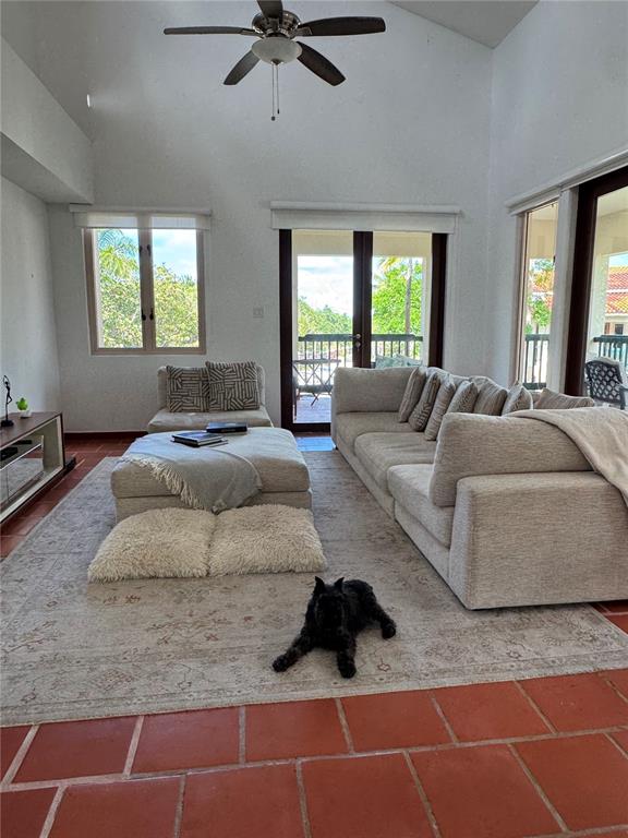 A living room features a vaulted ceiling, a large sectional sofa, and terracotta tile flooring — 86 LAKESIDE VILLAS UNIT F2, VEGA ALTA, PR