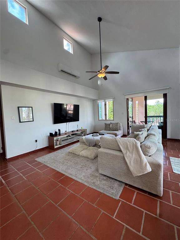 A living room features a vaulted ceiling, a ceiling fan, and terracotta tile flooring — 86 LAKESIDE VILLAS UNIT F2, VEGA ALTA, PR