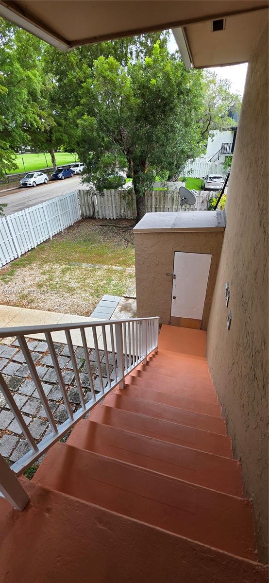 An outdoor staircase leads down to a small fenced yard with a storage closet — 8480 SW 154th Cir Ct # 925, Miami FL 33193, MIAMI, FL