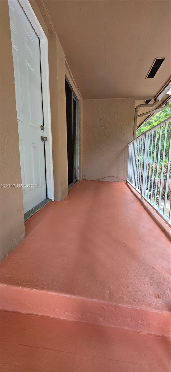 An outdoor balcony features a painted orange floor, a white door, and a metal railing — 8480 SW 154th Cir Ct # 925, Miami FL 33193, MIAMI, FL