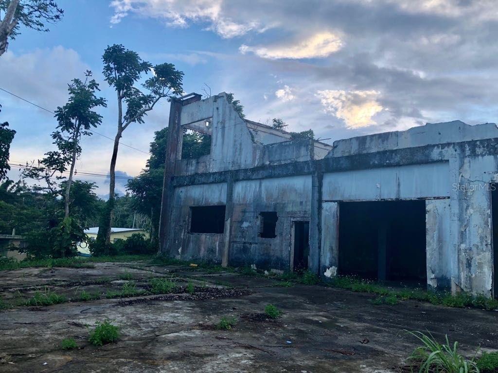 An exterior view of a dilapidated, multi-story concrete building with open window and door frames — LOT 1 PR 174 KM 22.7 SONADORA WARD, AGUAS BUENAS, PR