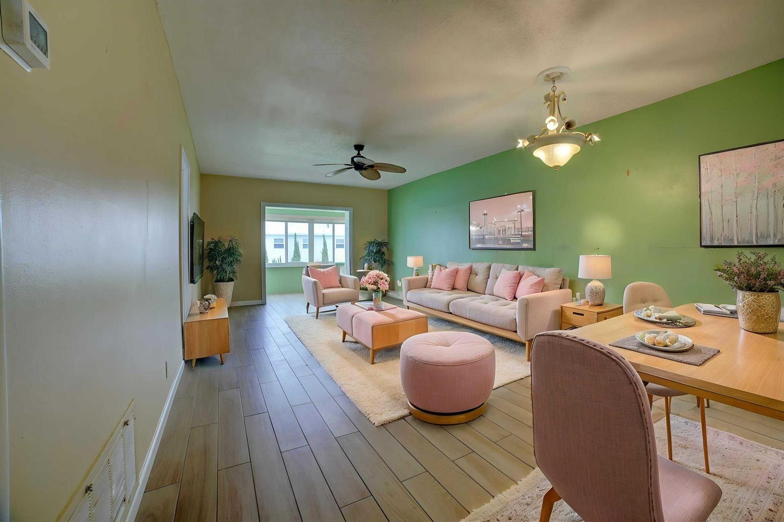 A living and dining area features green walls, light wood flooring, and pink accent furniture — 1118 Lake Terrace # 204, Boynton Beach FL 33426, BOYNTON BEACH, FL