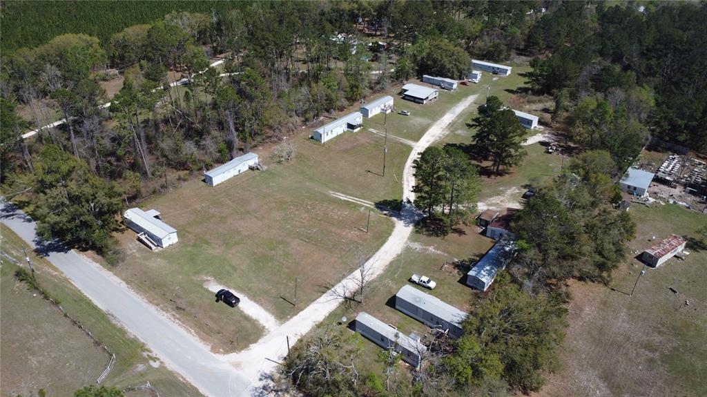 An aerial view shows a rural mobile home park with several trailers and gravel roads — 16790 82ND PLACE, LIVE OAK, FL