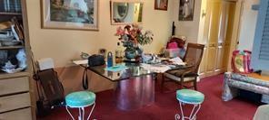 A dining area features a glass-topped table, two turquoise stools, and a wooden chair — 86 Westbury # 86, Deerfield Beach FL 33442, DEERFIELD BEACH, FL