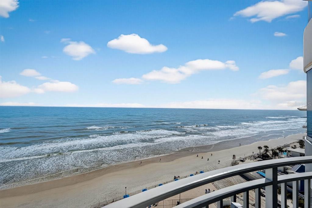 A high-angle view of a sandy beach and ocean from a balcony — 2625 S ATLANTIC AVENUE UNIT 14NE, DAYTONA BEACH, FL