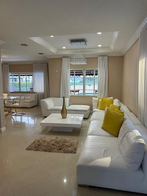 A living room features white leather sofas, a square coffee table, and large windows — 1710 SW 154th Path, Miami FL 33185, MIAMI, FL