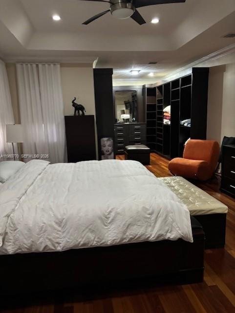 A bedroom features a large bed, a walk-in closet, and an orange accent chair — 1710 SW 154th Path, Miami FL 33185, MIAMI, FL
