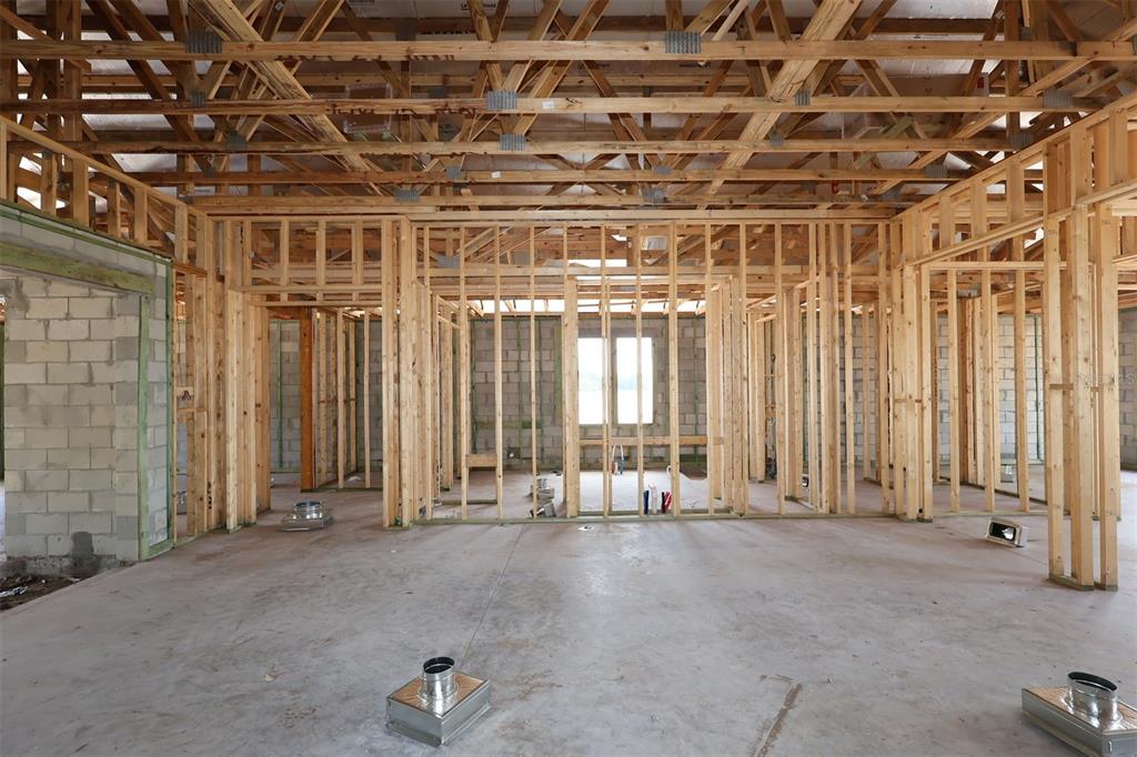 Interior view of a house under construction featuring exposed wood framing and concrete block walls — 3011 SOLACE WAY, ORLANDO, FL