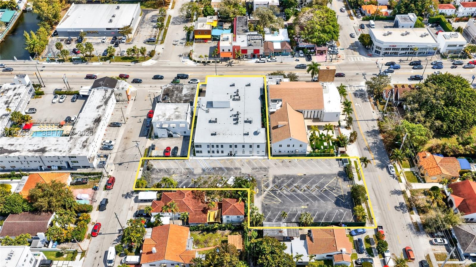 An aerial view shows a commercial building with an adjacent parking lot outlined in yellow — 7630 Biscayne Blvd, Miami FL 33138, MIAMI, FL