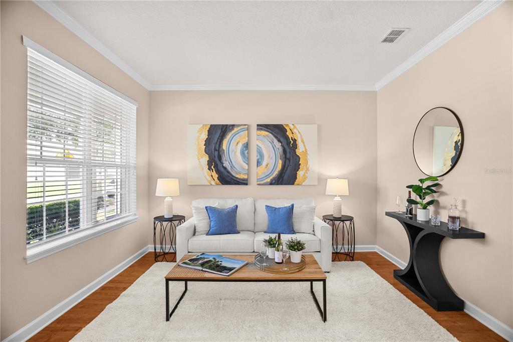 A living room features a white sofa, a wooden coffee table, and a console table — 14421 PARADISE TREE DRIVE, ORLANDO, FL