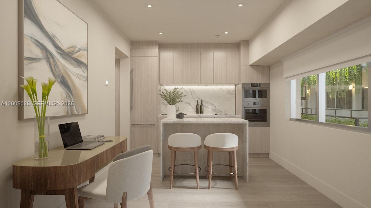 This rendering shows a modern kitchen with light wood cabinetry, marble countertops, and a desk — 260 Collins Ave # 205, Miami Beach FL 33139, MIAMI BEACH, FL