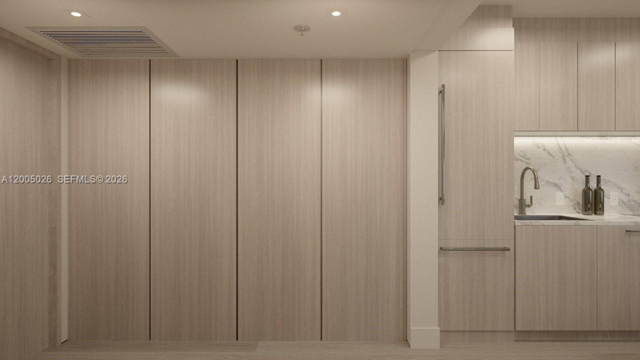 This rendering shows a modern kitchen with light wood cabinetry and a marble backsplash — 260 Collins Ave # 205, Miami Beach FL 33139, MIAMI BEACH, FL