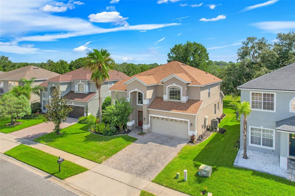 An aerial view of a two-story suburban house with a tan exterior and brown roof — 33519 TERRAGONA DRIVE, SORRENTO, FL