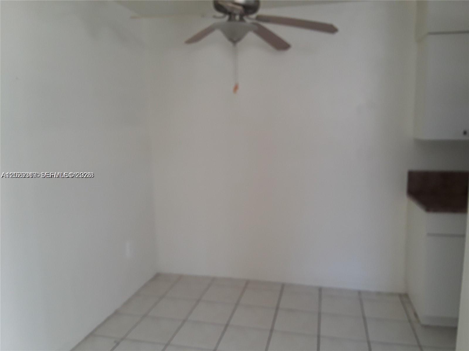 A room with white walls, a ceiling fan, and light-colored square floor tiles — 236 Madeira Ave # 6, Coral Gables FL 33134, CORAL GABLES, FL