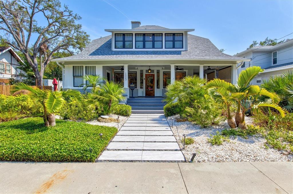 A single-story house with a large front porch, a dormer window, and a paved walkway — 1523 1ST AVENUE W, BRADENTON, FL