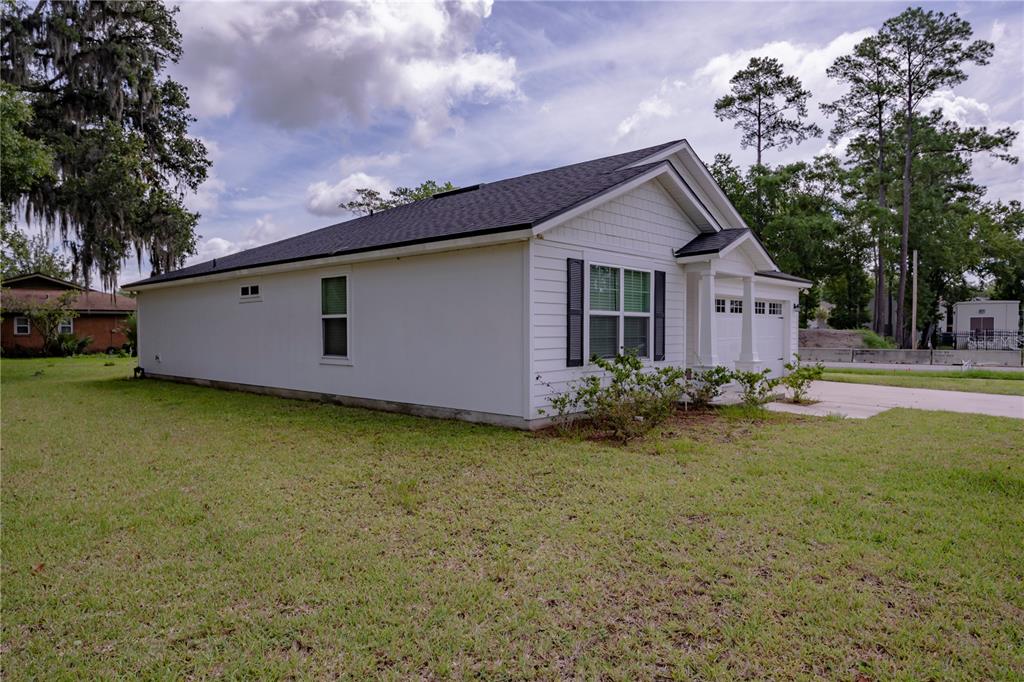A white single-story house with a dark roof and a two-car garage — 805 TURTLE CREEK DRIVE S, JACKSONVILLE, FL