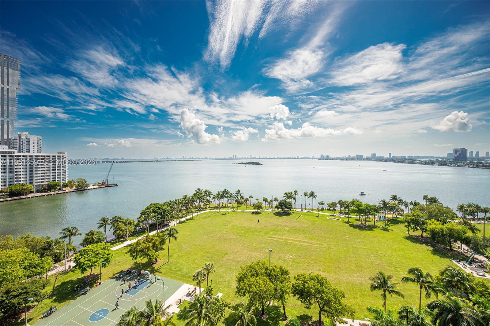 An elevated view of a waterfront park with a basketball court and high-rise buildings — 1900 N BAYSHORE DR, Miami FL 33132, MIAMI, FL