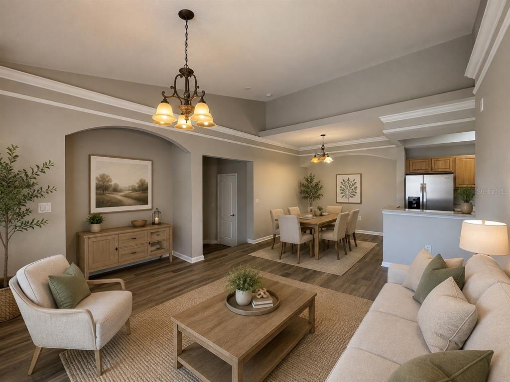 An open-concept living and dining area features neutral walls, wood-look flooring, and vaulted ceilings — 12021 VILLANOVA DRIVE UNIT 112, ORLANDO, FL
