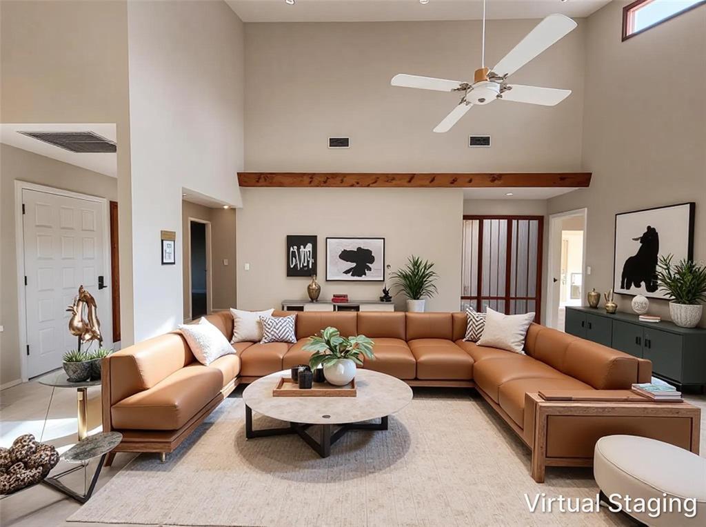 This living room features a large tan sectional sofa, a round coffee table, and high ceilings — 1407 WILLOW OAK CIRCLE UNIT 1407, BRADENTON, FL