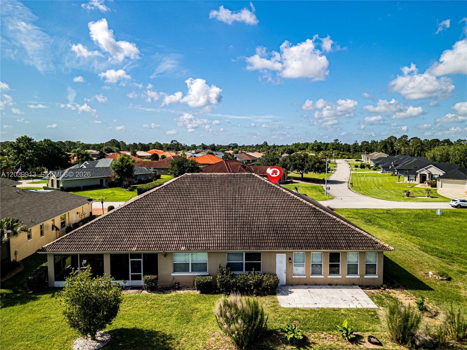 An aerial view shows the rear exterior of a single-story house with a tiled roof — 6938 Cecilia Ave, Sebring FL 33872, SEBRING, FL