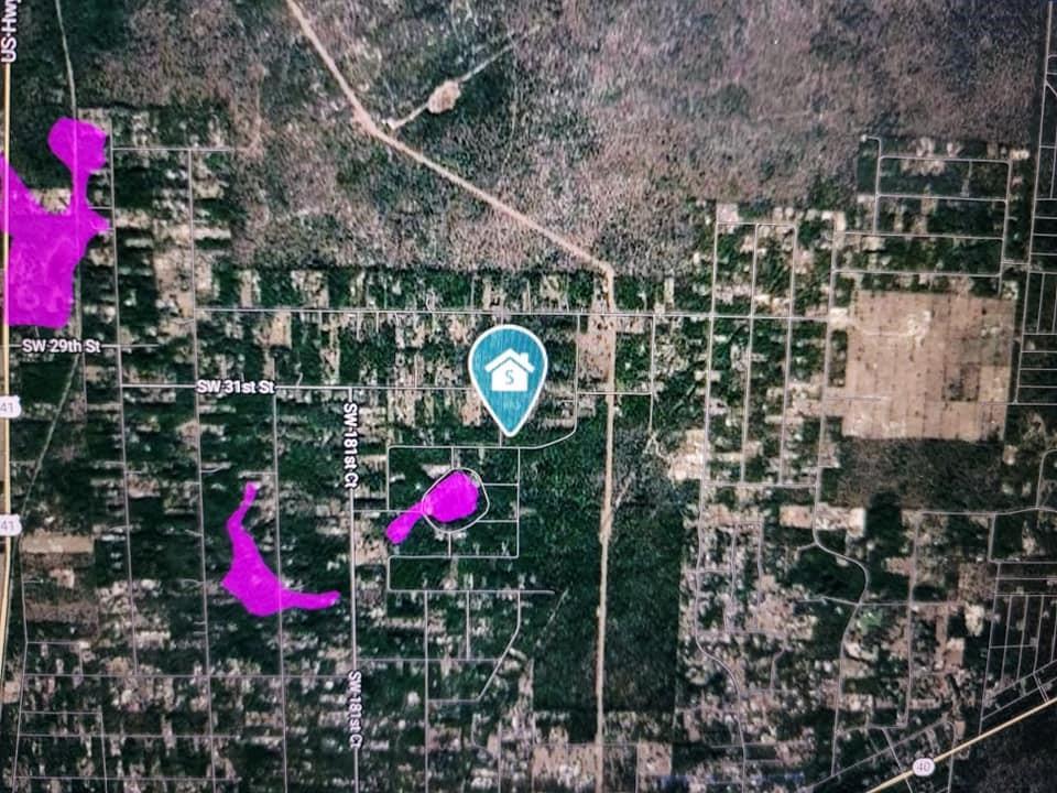 This is a satellite map showing a property location marker and surrounding wooded residential lots — 0 SW 34 Street, FL 34432, FL