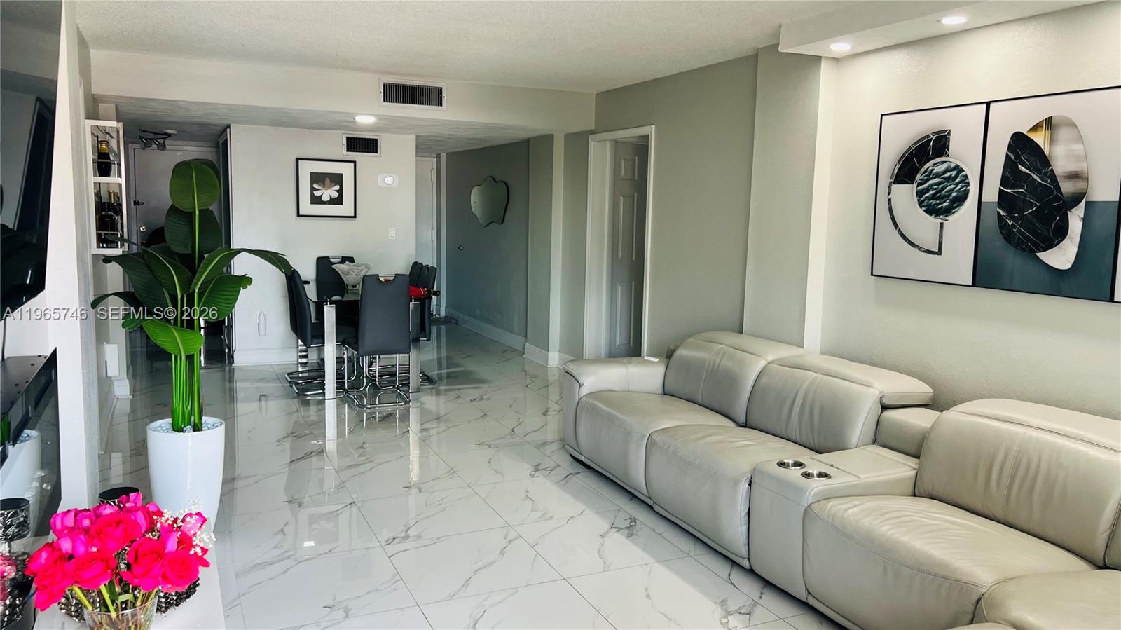 A living room and dining area feature light gray walls, white marble-look tile floors, and modern furniture — 14250 SW 62nd St # 319, Miami FL 33183, MIAMI, FL