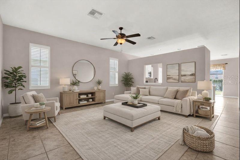 This living room features a sectional sofa, a large ottoman, and a wooden media console — 14316 HOLLY HAMMOCK LANE, BROOKSVILLE, FL