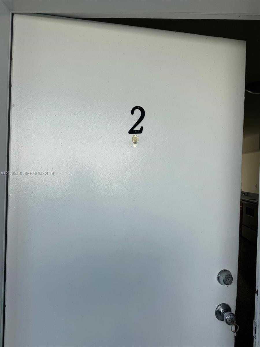 A white door labeled with the number two features a peephole and two locks — 680 NE 88th Ter # 2, Miami FL 33138, MIAMI, FL