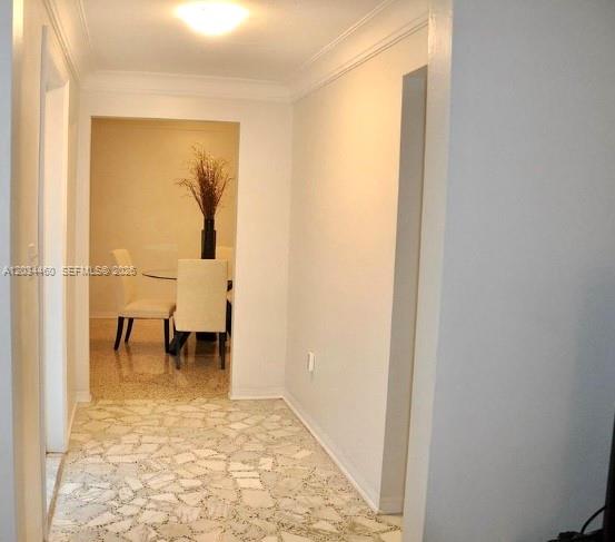 A hallway with terrazzo flooring leads to a dining area featuring a table and chairs — 400 Miller Rd, Coral Gables FL 33146, CORAL GABLES, FL