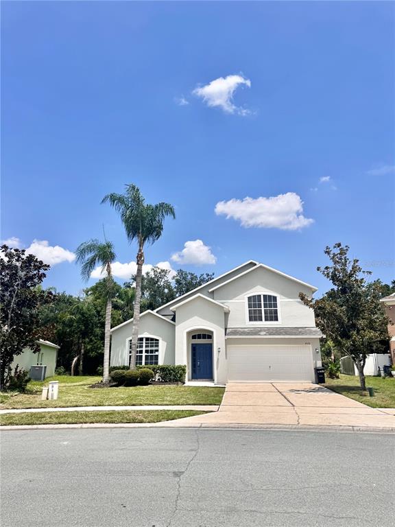 A two-story house with a light-colored exterior, a blue front door, and two palm trees — 420 MARATHON LANE, SANFORD, FL