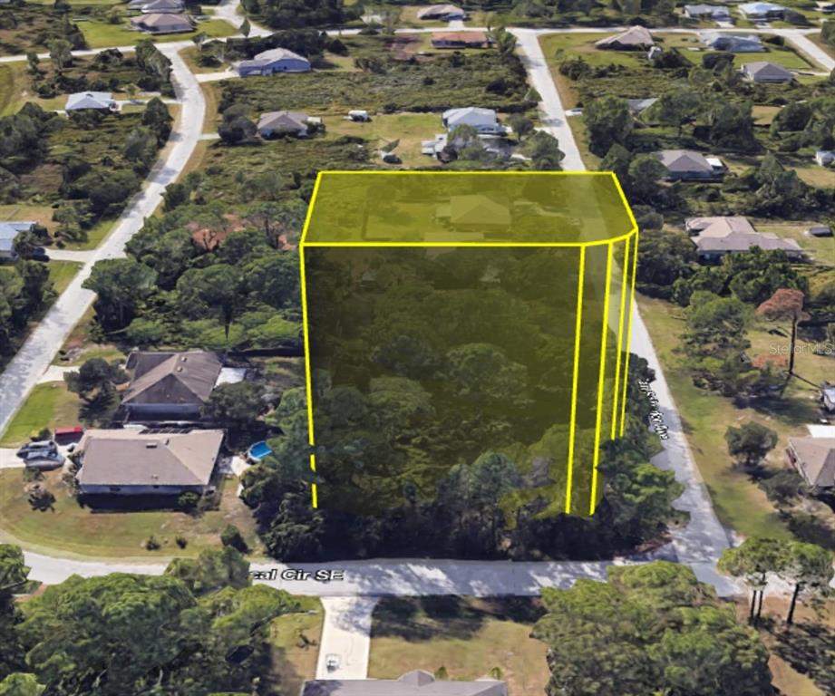 An aerial view shows a wooded residential lot highlighted with a yellow outline — SAN SALVADOR AVENUE SE, PALM BAY, FL