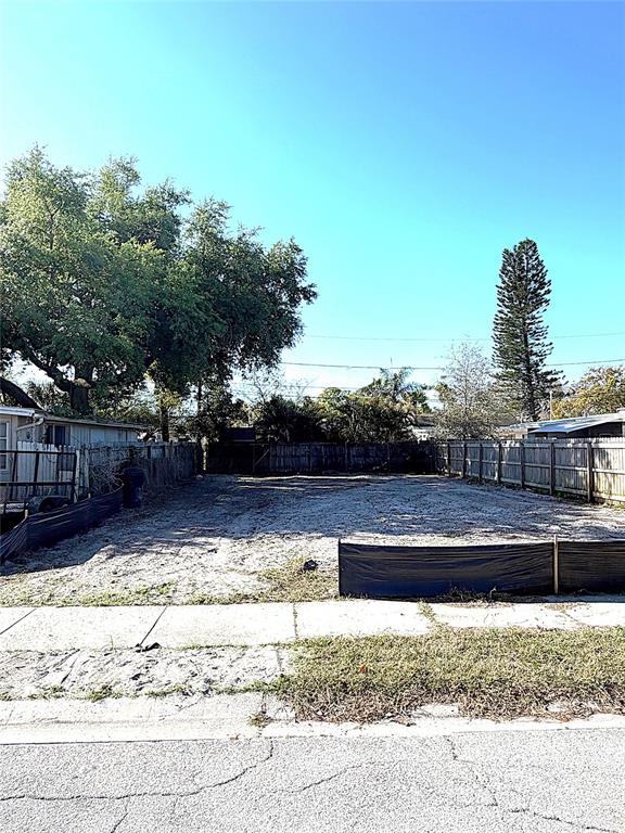 A vacant, cleared residential lot is enclosed by a wooden fence and black silt fencing — 2126 43RD AVENUE N, ST PETERSBURG, FL