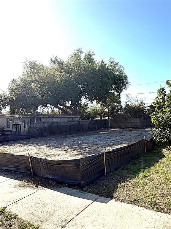 A vacant, cleared residential lot is enclosed by black silt fencing under a clear sky — 2126 43RD AVENUE N, ST PETERSBURG, FL