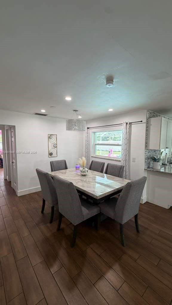 A dining room features a marble-topped table, six gray upholstered chairs, and wood-look flooring — 244 SE 46TH ST, Cape Coral FL 33904, CAPE CORAL, FL