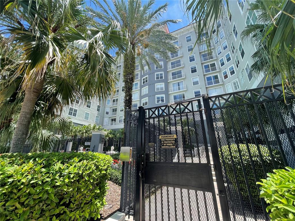 A multi-story apartment building exterior with palm trees and a gated entrance — 700 S HARBOUR ISLAND BOULEVARD UNIT 110, TAMPA, FL