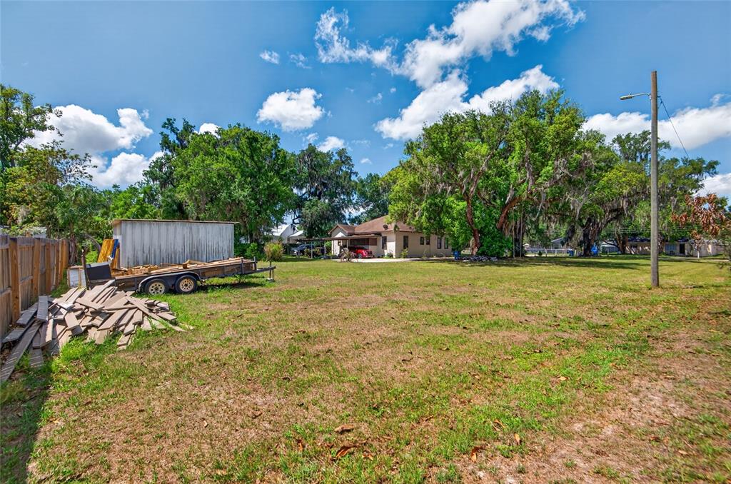A living room features a beige sectional sofa, a round coffee table, and built-in shelving — 200 N ORANGE AVENUE, FORT MEADE, FL