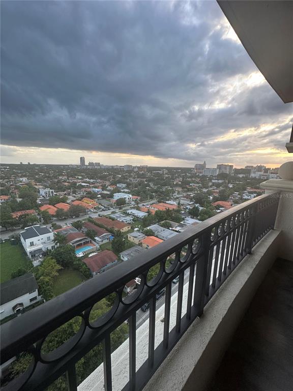 A high-angle view from a balcony overlooking a suburban neighborhood under a cloudy sky — 3232 CORAL WAY UNIT 1607, MIAMI, FL