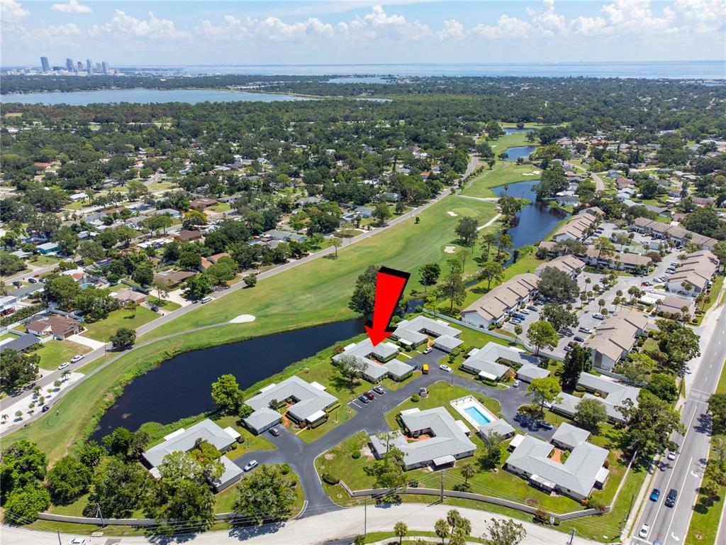An aerial view shows a residential complex with a red arrow pointing to a unit — 2187 CORINNE COURT S UNIT C, ST PETERSBURG, FL