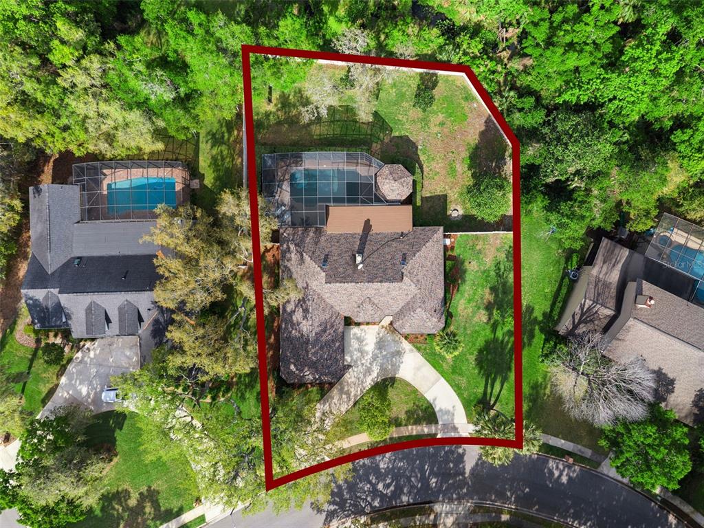 An aerial view shows a house with a pool and a large backyard on a lot — 441 WILD OAK CIRCLE, LONGWOOD, FL