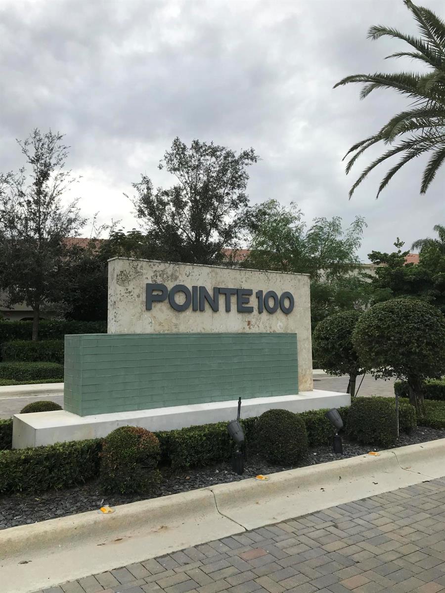 A stone monument sign with the text POINTE 100 stands in front of landscaped shrubbery — 23045 Clear Echo Drive # 76, Boca Raton FL 33433, BOCA RATON, FL