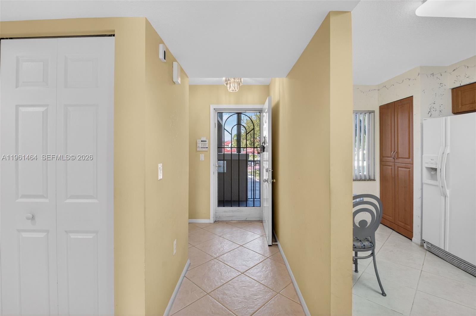 A tiled entryway leads to an open front door with a decorative metal security gate — 12540 Majesty Cir # 208, Boynton Beach FL 33437, BOYNTON BEACH, FL