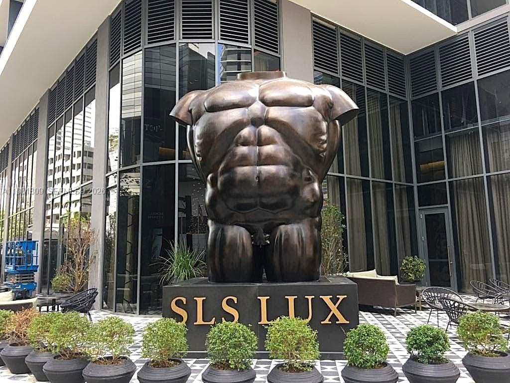 A large bronze torso sculpture stands on a pedestal in front of a modern building — 801 S Miami Ave # 1203, Miami FL 33130, MIAMI, FL