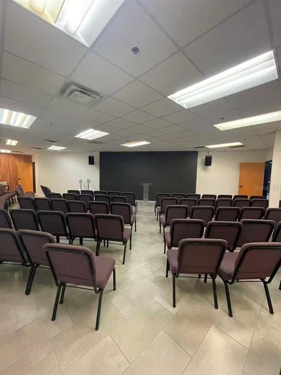 A room set up with rows of chairs facing a black wall and a podium — 7075 KINGSPOINTE PARKWAY UNIT 9, ORLANDO, FL