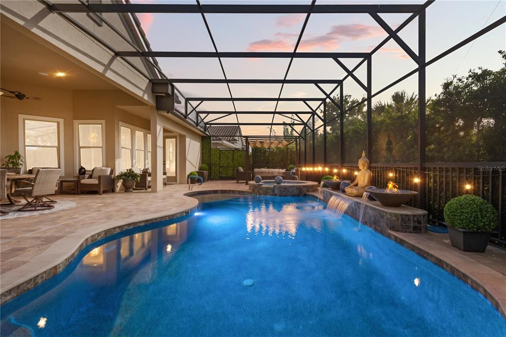 A screened-in patio features a swimming pool, a hot tub, and a Buddha statue fountain — 3880 GRASSLAND LOOP, LAKE MARY, FL