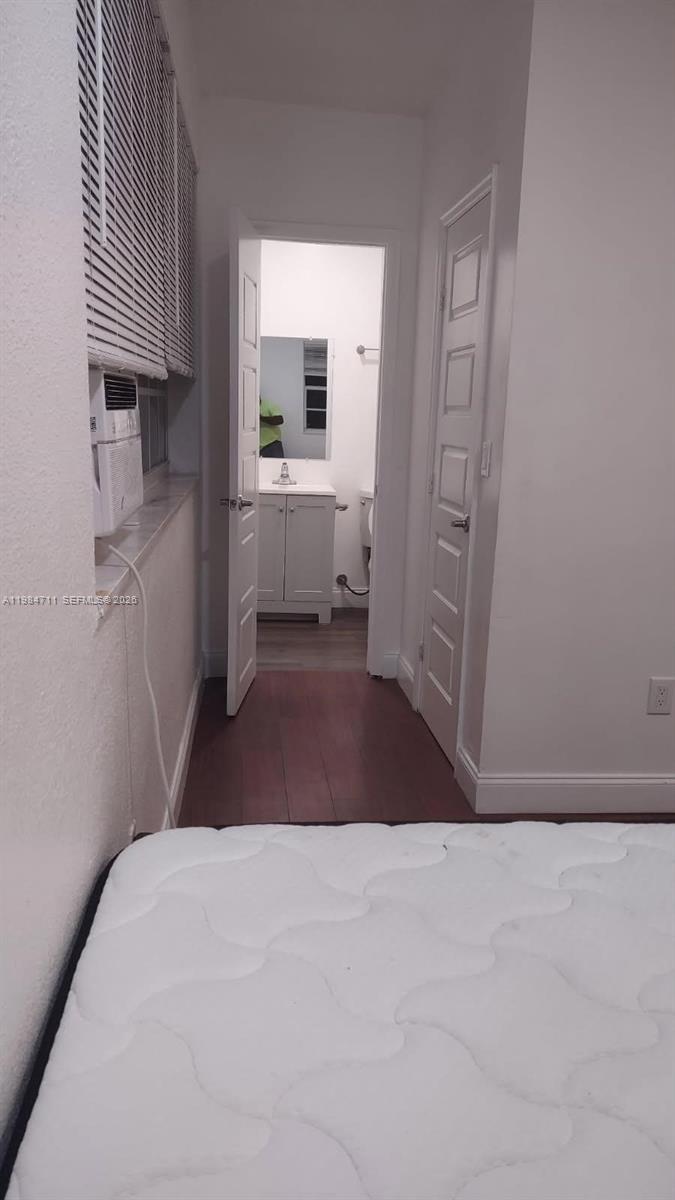 A bedroom with a mattress in the foreground leads to an open bathroom doorway — 13301 NW 31st Ave # 1, Opa-Locka FL 33054, OPA-LOCKA, FL
